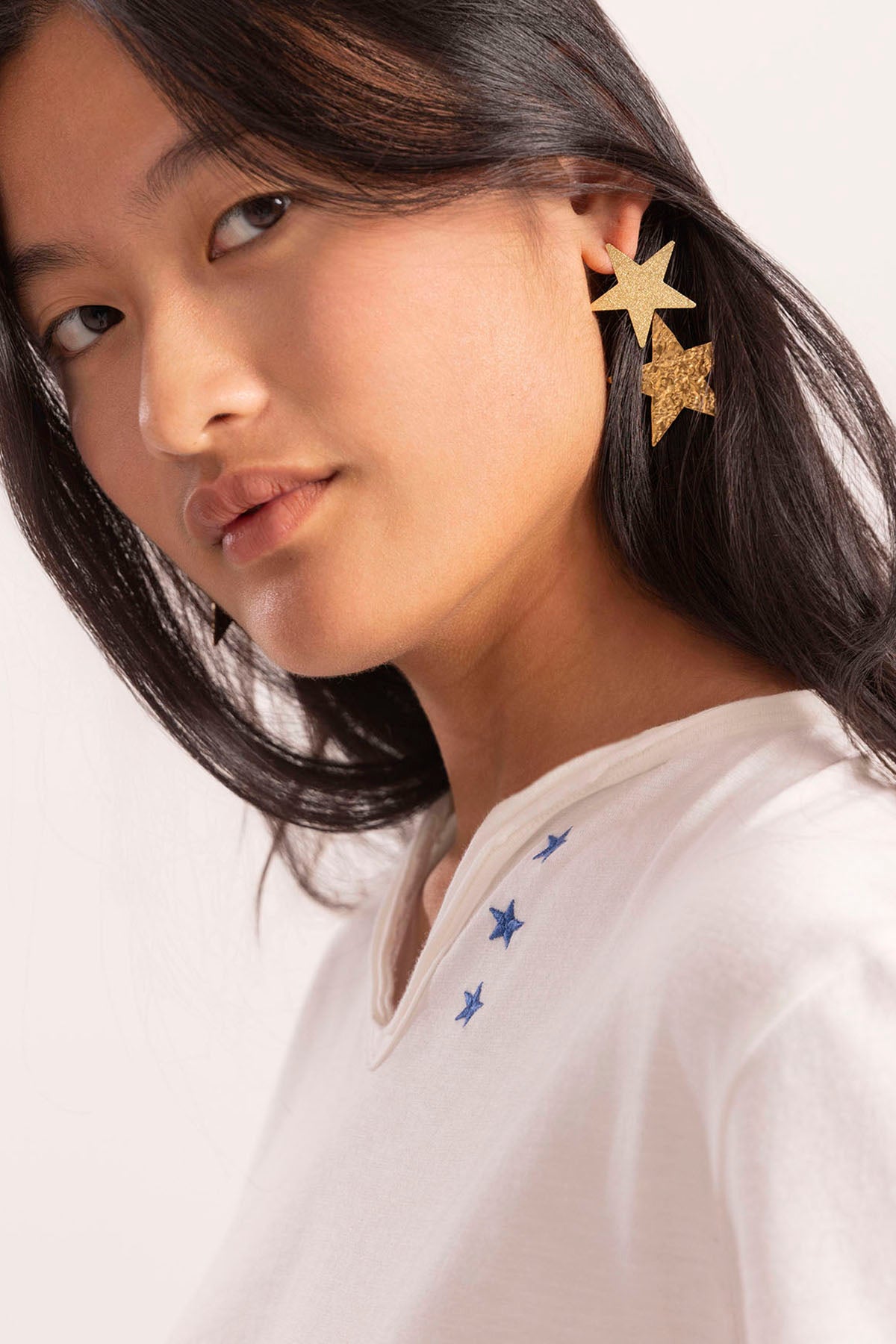 T-SHIRT ADOLESCENTE COM BOTÕES DE ESTRELAS E CONTRASTE EM BRANCO PURO